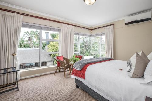 a bedroom with a bed and a large window at Atlantic Breeze in Cape Town