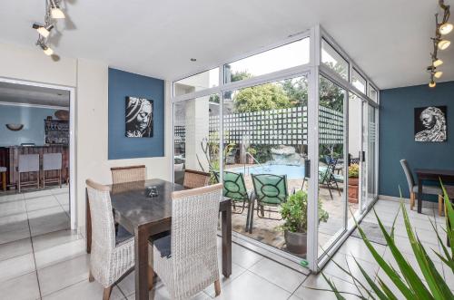 a dining room with a table and chairs at Atlantic Breeze in Cape Town