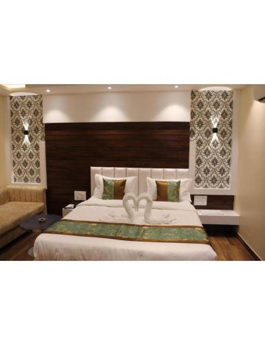 - une chambre avec un grand lit et un canapé dans l'établissement Hotel President, Jodhpur, à Jodhpur