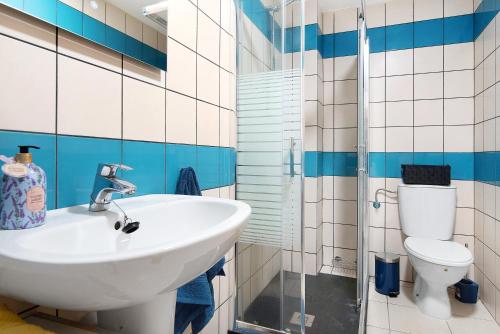 a bathroom with a sink and a toilet at El Refugio in Sardina