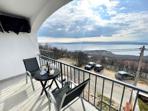 a balcony with a table and chairs and a view at Apartment in Dramalj 42941 in Dramalj