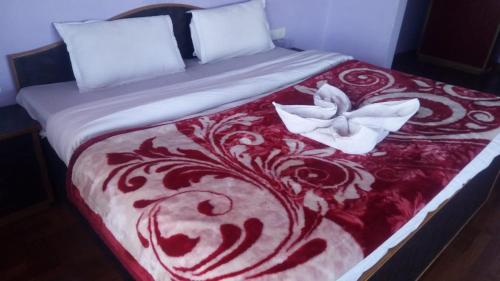 a red and white bed with two white butterflies on it at Brahma Kamal in Munsyari