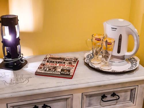 a counter with a coffee maker and a book on it at Gościna U kowala in Lachowice