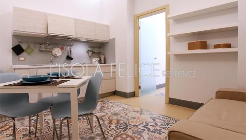 a kitchen and dining room with a table and chairs at L'isola Felice in Trapani