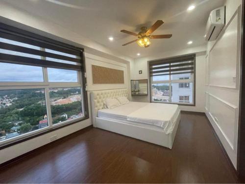 a bedroom with a bed and a ceiling fan at (Best Seller) Very nice 3 bedroom apartment in Ha Long in Ha Long