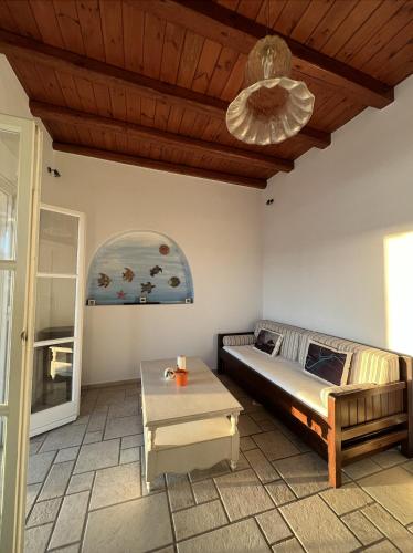 a living room with a bed and a table at Yalos Mykonos Ornos Pouli private apartments w shared swimming pool in Mýkonos City
