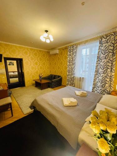 a bedroom with a bed with yellow flowers on it at ГОК Віват in Morshin