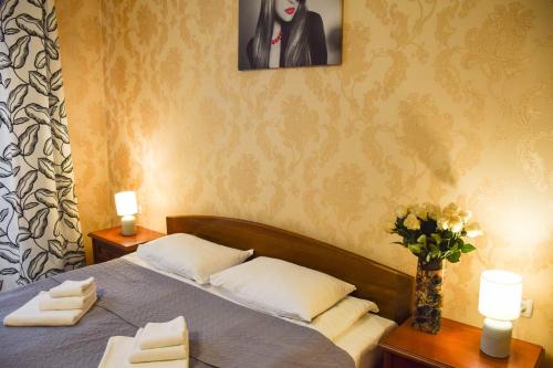 a bedroom with a bed with towels and a vase of flowers at ГОК Віват in Morshin