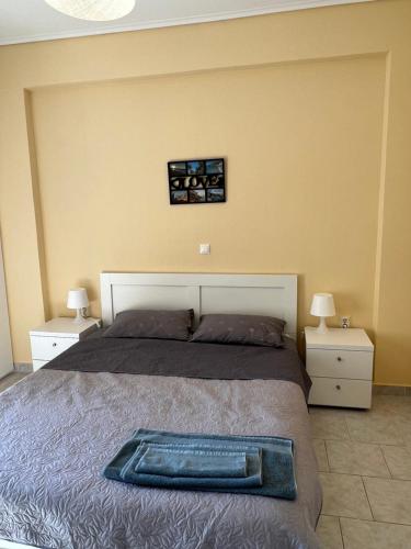 a bedroom with a bed with a tray on it at Comfort apartment for small family in Loutraki
