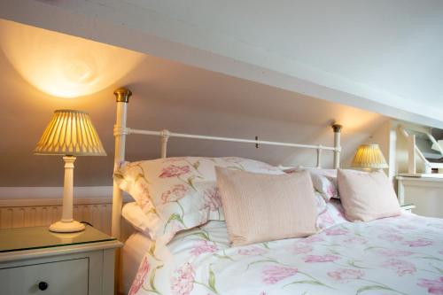 a bedroom with a bed and two lamps on a table at The Pack Horse Exmoor National Park Allerford Riverside Cottage & Apartments in Minehead