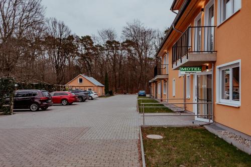 a building with a sign on the side of a street at Motel Zur Dachsbaude in Wandlitz