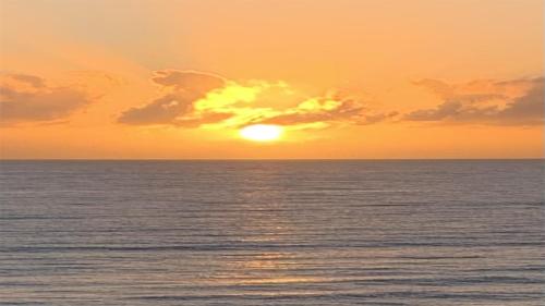 a sunset over the ocean with the sun setting at Welooveyou Zafiro's in Morro del Jable