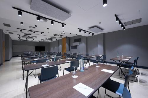 a large room with tables and chairs and a podium at Catalonia La Maquinista in Barcelona