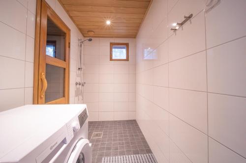 a bathroom with a washer and dryer in it at Reininlaakso Ainola in Levi