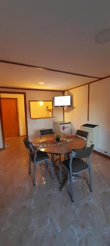 ein Esszimmer mit einem Holztisch und Stühlen in der Unterkunft M&M ll in Comodoro Rivadavia