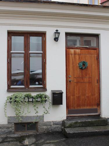 a house with a wooden door and two windows at Lilla Hotellet in Sundsvall