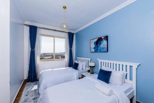 Ένα ή περισσότερα κρεβάτια σε δωμάτιο στο Sapphire Expressway Suite near JKIA SGR