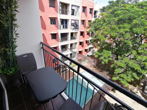 balcone con sedia e vista su un edificio di Condo Azur Suites E507 near Airport, Netflix, Stylish, Cozy with swimming pool a Lapu Lapu City