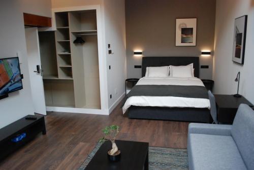 a hotel room with a bed and a couch at Altar Suites Caño Badillo by gaiarooms in León
