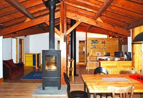 a living room with a wood stove in a house at Laroche in Barbaste
