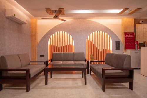 a waiting room with two couches and a table at Holy Shivana Boutique Hotel Rishikesh in Rishīkesh