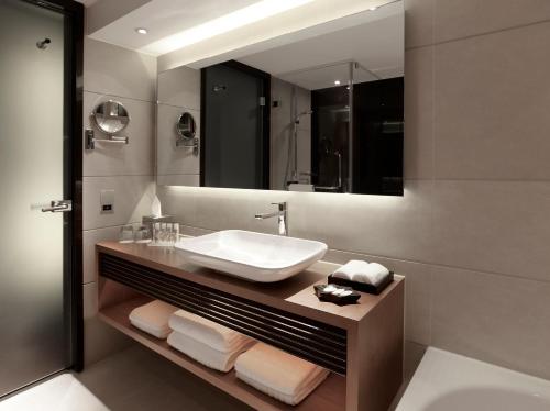 a bathroom with a sink and a mirror at Park Plaza London Westminster Bridge in London