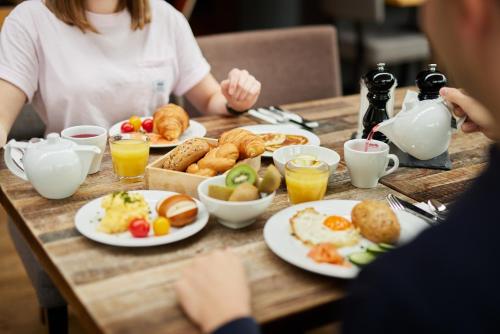 a table with plates of breakfast food on it at co56 Hotel Chemnitz in Chemnitz