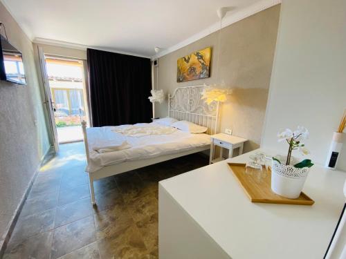 a bedroom with a bed and a table in a room at Vamyami Vama Veche in Vama Veche