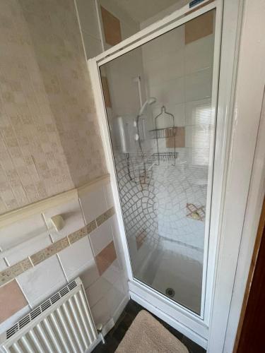 a shower with a glass door in a bathroom at Nevele in Blackpool