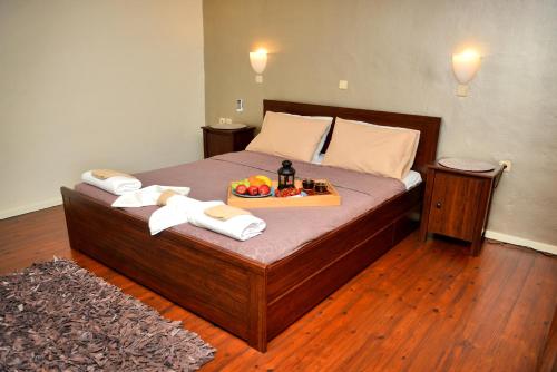 a bedroom with a bed with a tray of fruit on it at Xenios Zeus Maisonettes Old Town Rhodes in Rhodes Town