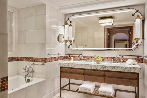 a bathroom with a sink and a tub and a mirror at Four Seasons Hotel Istanbul at Sultanahmet in Istanbul