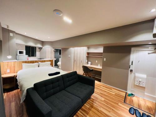 a bedroom with a large bed and a couch at ZDT-511 in Tokyo