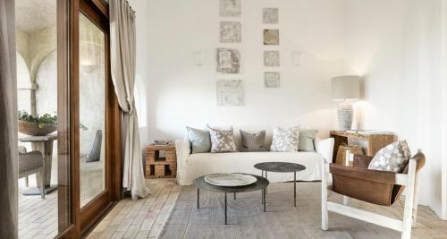 a living room with a white couch and a table at Cascioni Eco Retreat in Arzachena