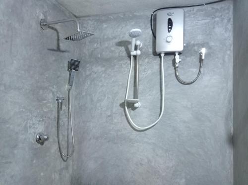 a bathroom with a shower and a shower head at SK HOUSE RESORT UNAWATUNA in Unawatuna