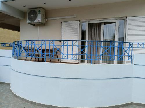 a balcony of a house with blue railing at JULIA'S APARTMENT in Igoumenitsa