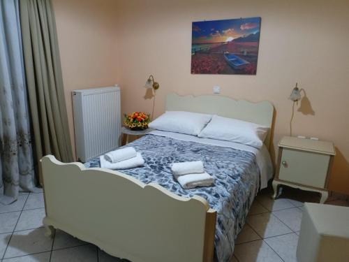 a bedroom with a bed with two pillows on it at JULIA'S APARTMENT in Igoumenitsa