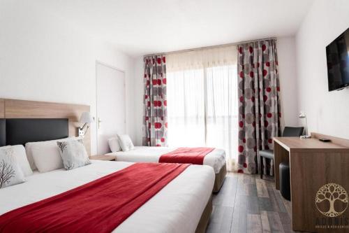 ル・カネにあるAdonis Cannes - Hôtel Thomasのベッド2台とテレビが備わるホテルルームです。