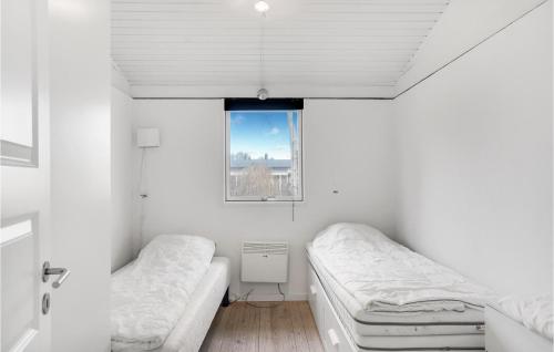 a white room with two beds and a window at Amazing Home In Frederikshavn With Wifi in Frederikshavn