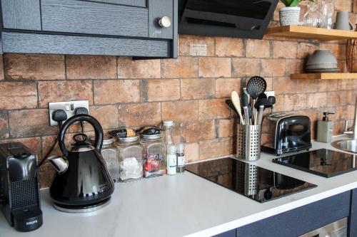 a kitchen counter with a tea kettle and utensils at no 12 - Stunning Self Check-in Apartments in Worcester Centre in Worcester