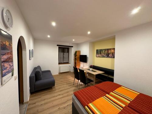 a bedroom with a bed and a desk with a chair at Ferienwohnung Wohlfahrter in Bad Mitterndorf