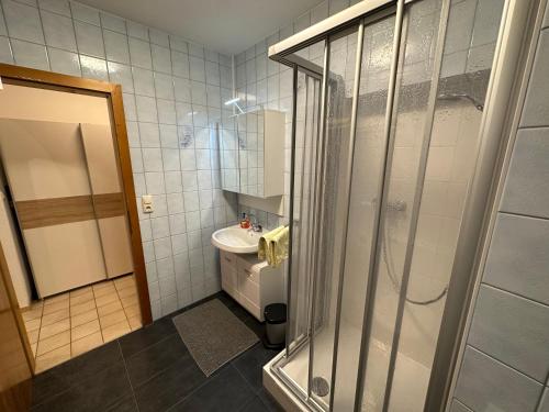 y baño con ducha y lavamanos. en Ferienwohnung Wohlfahrter en Bad Mitterndorf