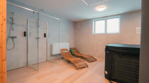 a bathroom with two chairs and a shower at Apartmán 101 Vila Zuberec in Zuberec