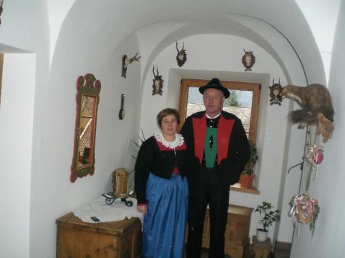 a man and a woman standing in a room at Kampflhof Apartments in Schenna