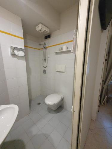 a bathroom with a toilet and a sink at Hotel Cumilì in Capo di Ponte