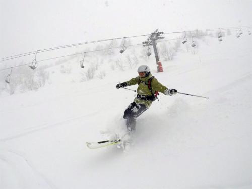 a person is skiing down a snow covered slope at Chalet Aventure B&B Les Gets in Les Gets