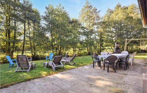 a group of chairs and tables in a yard at Amazing Home In Bonneville-La-Louvet in Bonneville-la-Louvet