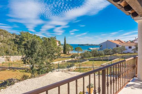 a balcony with a view of the water at Holiday Home Irena-Adriatic Luxury Villas in Žman