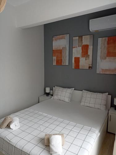 a bedroom with a large white bed with two towels at Apartment SEA HOLIDAYS in Burgas