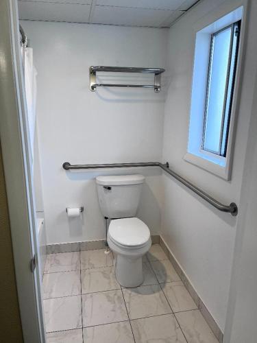 a bathroom with a toilet and a window at Sahara Motel in Ocean City