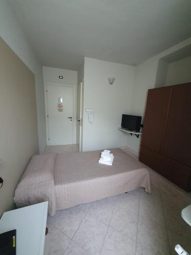 a small bedroom with a bed and a closet at Hotel Cumilì in Capo di Ponte